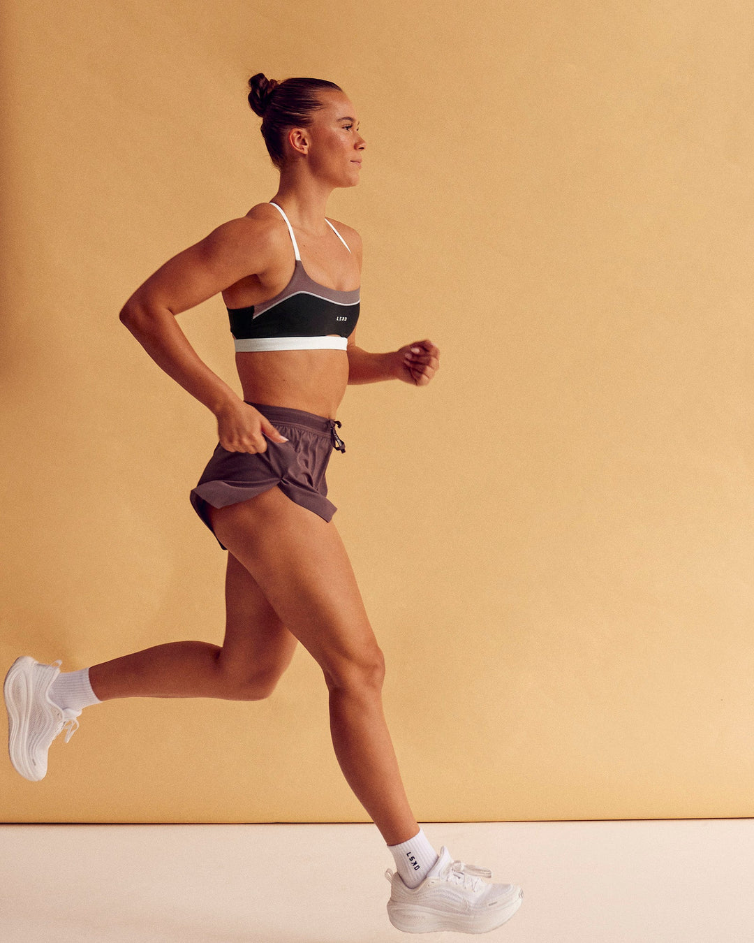 Woman wearing Accelerate 3" High-Rise Running Short - Cocoa Powder | Model:Charlize | Size:S
