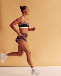 Woman wearing Accelerate 3" High-Rise Running Short - Cocoa Powder | Model:Charlize | Size:S