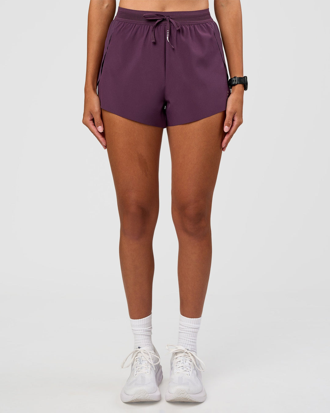 Woman wearing Accelerate 3" High-Rise Running Short - Midnight Plum | Set:true | Angle:front | Model:Rhiley | Size:S