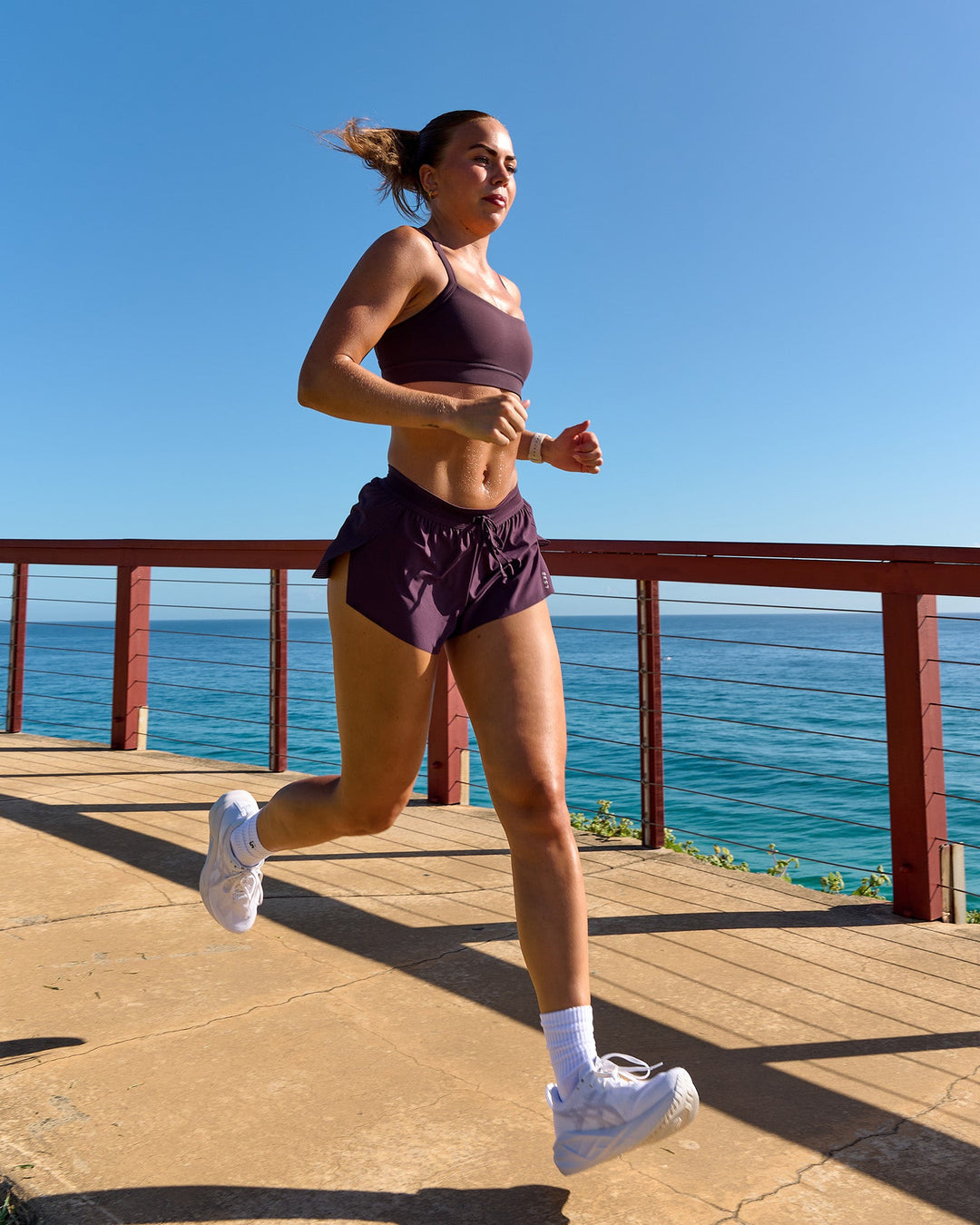 Woman wearing Accelerate 3" Mid-Rise Running Short - Midnight Plum | Model:Roisin | Size:S