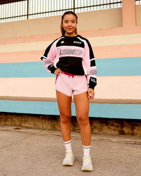 Woman wearing Accelerate 3" Mid-Rise Running Short - Scarlet-Marshmallow | Model:Clare | Size:S