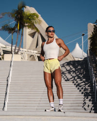 Woman wearing Accelerate 3" Mid-Rise Running Short - Yellow Fizz | Model:Emily | Size:S