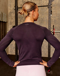 Woman wearing AeroFLX+ Seamless Long Sleeve Tee - Midnight Plum/Midnight Plum | Model:Charli | Size:XS