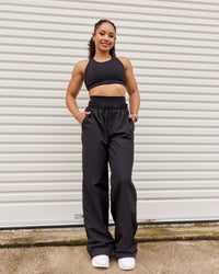 Woman wearing Ascent Sports Bra - Black | Model:Tarnie | Size:S