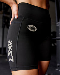 Woman wearing Fusion Hype Graphic Ultra High-Rise 6" Short Pockets - Black-Alloy | Model:Erin | Size:S