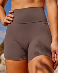 Woman wearing Fusion Ultra High-Rise 4" Short Pockets - Peppercorn | Model:Rica | Size:S