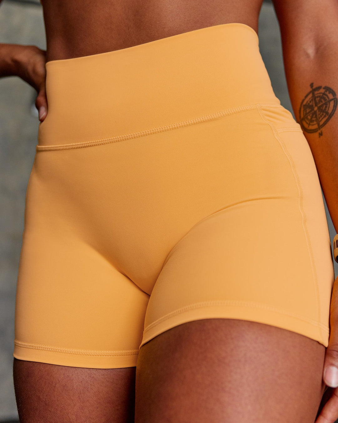 Woman wearing Fusion Ultra High-Rise 4&quot; Short Pockets - Warm Apricot | Model:Janet | Size:S