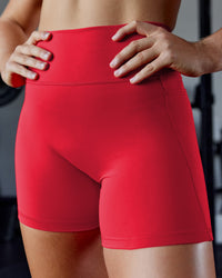 Woman wearing Fusion Ultra High-Rise 6" Short Pockets - Scarlet | Model:Pam | Size:S