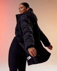 Woman wearing Go-To Puffer Long Jacket - Black | Model:Rhiley | Size:S