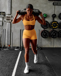 Woman wearing Interstellar Sports Bra - Warm Apricot | Model:Janet | Size:S