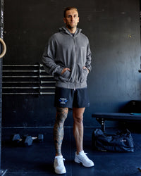 Man wearing Relentless Washed Zip Through Oversized Hoodie - Dark Storm-White | Model:Tommy | Size:S