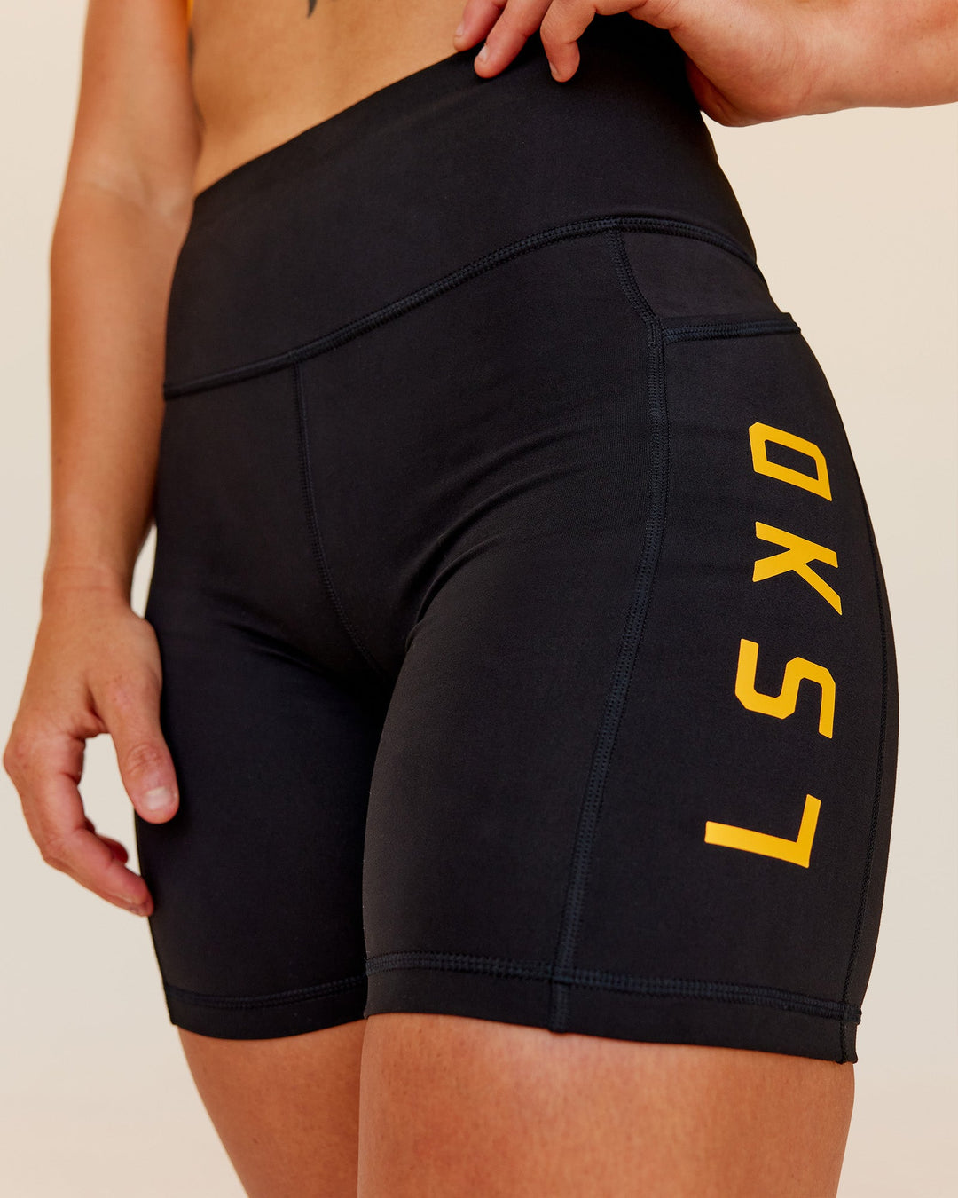 Woman wearing Rep Ultra High-Rise 6" Short Pockets - Black-Zinnia | Model:Tenaya | Size:S