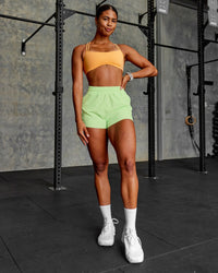 Woman wearing Sport Short 2.5" - Solar Lime | Model:Janet | Size:S