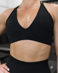 Woman wearing Stamina Pulse Sports Bra - Black | Model:Sarah | Size:S