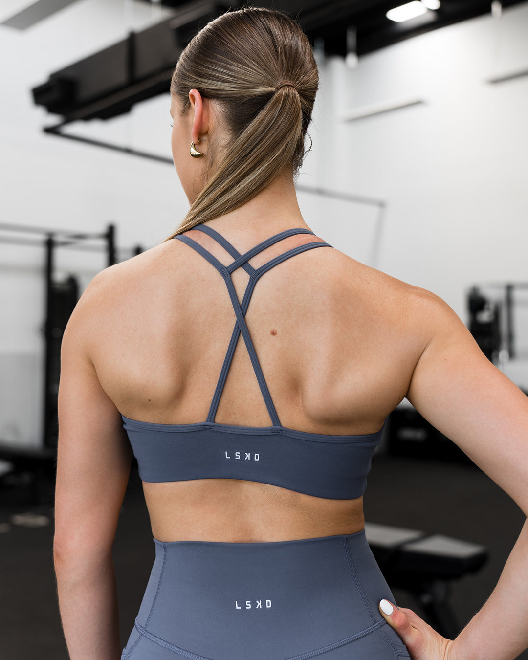 Woman wearing Stamina Pulse Sports Bra - Night Shadow | Model:Sarah | Size:S