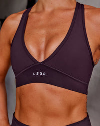 Woman wearing Stamina Sports Bra - Midnight Plum | Model:Roisin | Size:S