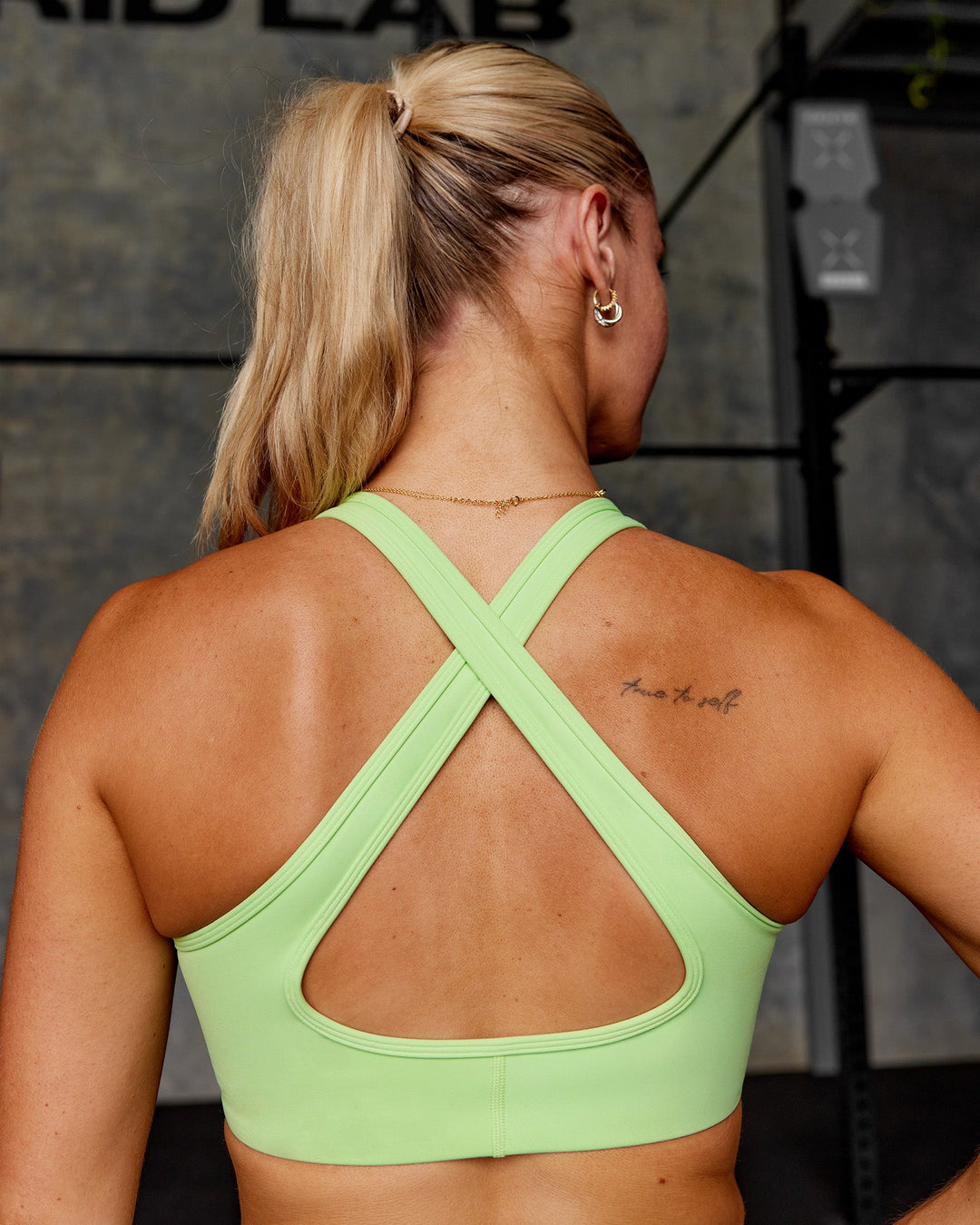 Woman wearing Stamina Sports Bra - Solar Lime | Model:Hannah | Size:S
