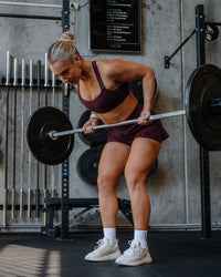 Woman wearing Velocity Sports Bra - Cherry Lacquer | Model:Lyss | Size:S
