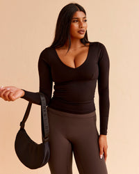 Woman wearing Vitality Long Sleeve Top - Black | Model:Nikki | Size:S