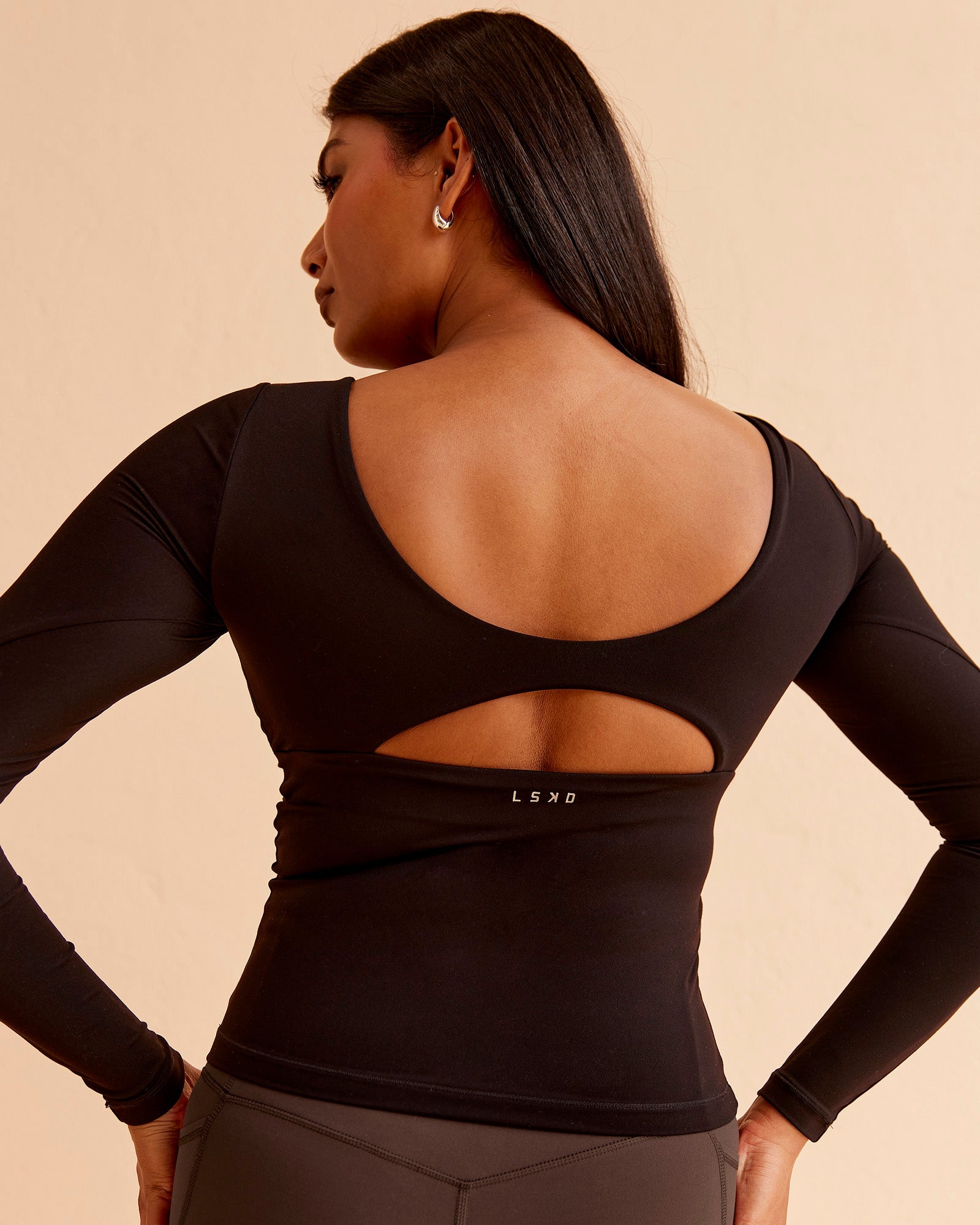 Woman wearing Vitality Long Sleeve Top - Black | Model:Nikki | Size:S