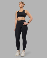 Woman wearing Stability Sports Bra - Black | Model:Amy | Size:S (D-E Cup)