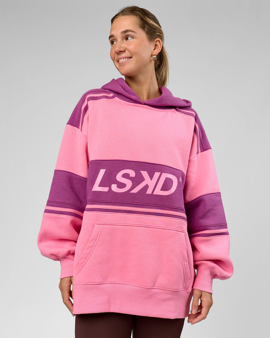 Woman wearing A-Team Oversized Hoodie - Candy Pink-Boysenberry | Model:Amity | Size:S