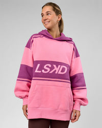 Woman wearing A-Team Oversized Hoodie - Candy Pink-Boysenberry | Model:Amity | Size:S