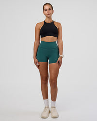 Woman wearing AMRAP High Neck Sports Bra - Black | Model:Myrte | Size:S