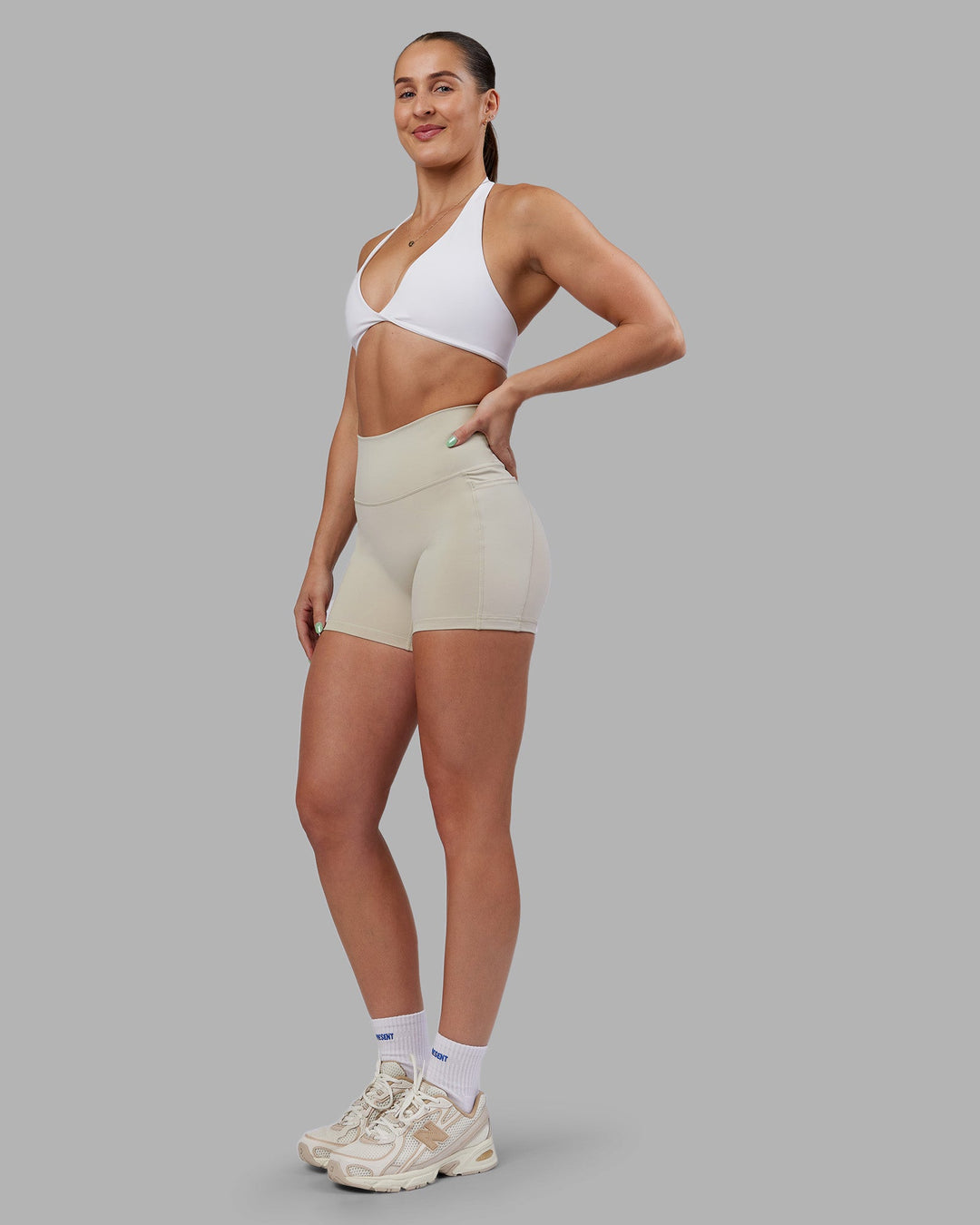 Woman wearing Abs Agile Halter Sports Bra - White | Model:Abbey | Size:S