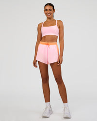 Woman wearing Accelerate 3" High-Rise Running Short - Cantaloupe-Marshmallow | Model:Ruby | Size:S
