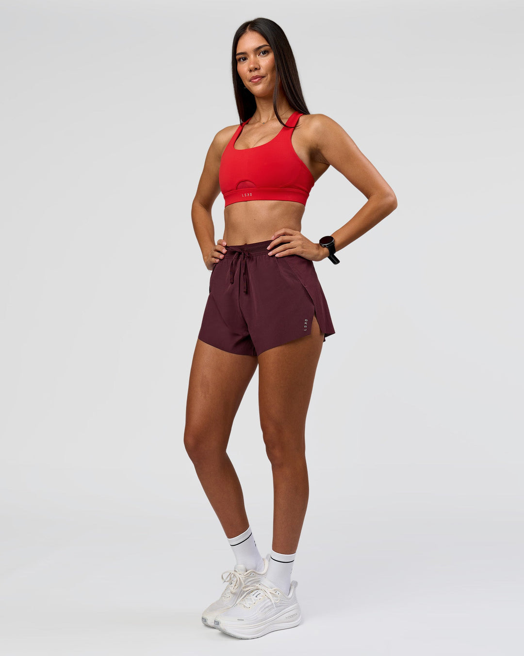 Woman wearing Accelerate 3" High-Rise Running Short - Cherry Lacquer | Model:Rhiley | Size:S