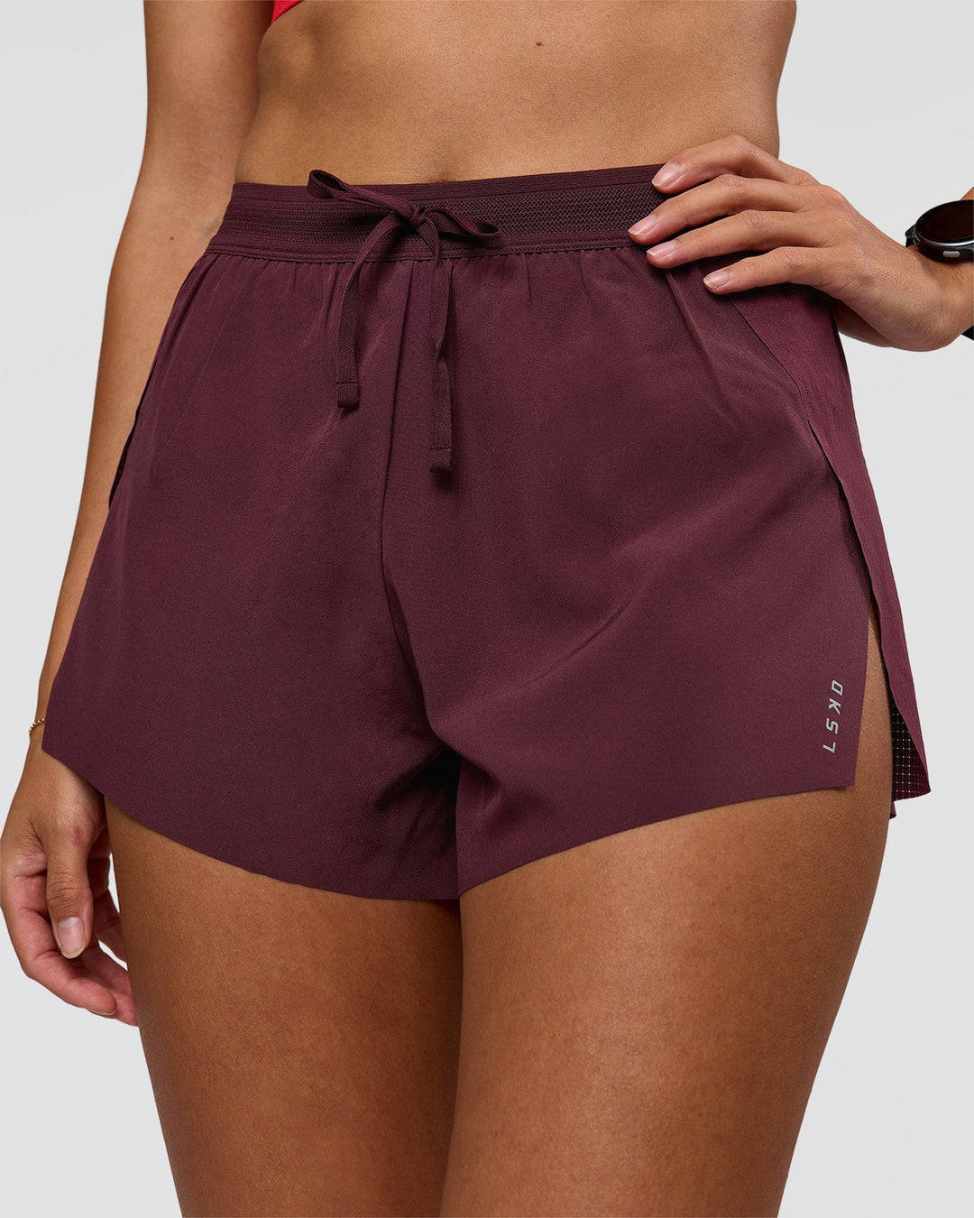 Woman wearing Accelerate 3" High-Rise Running Short - Cherry Lacquer | Model:Rhiley | Size:S