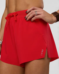 Woman wearing Accelerate 3" High-Rise Running Short - Flame | Set:true | Angle:closeup | Model:Zara | Size:S