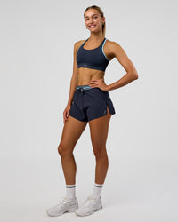 Woman wearing Accelerate 3" High-Rise Running Short - Future Navy-Baltic Sea | Model:Evie | Size:S