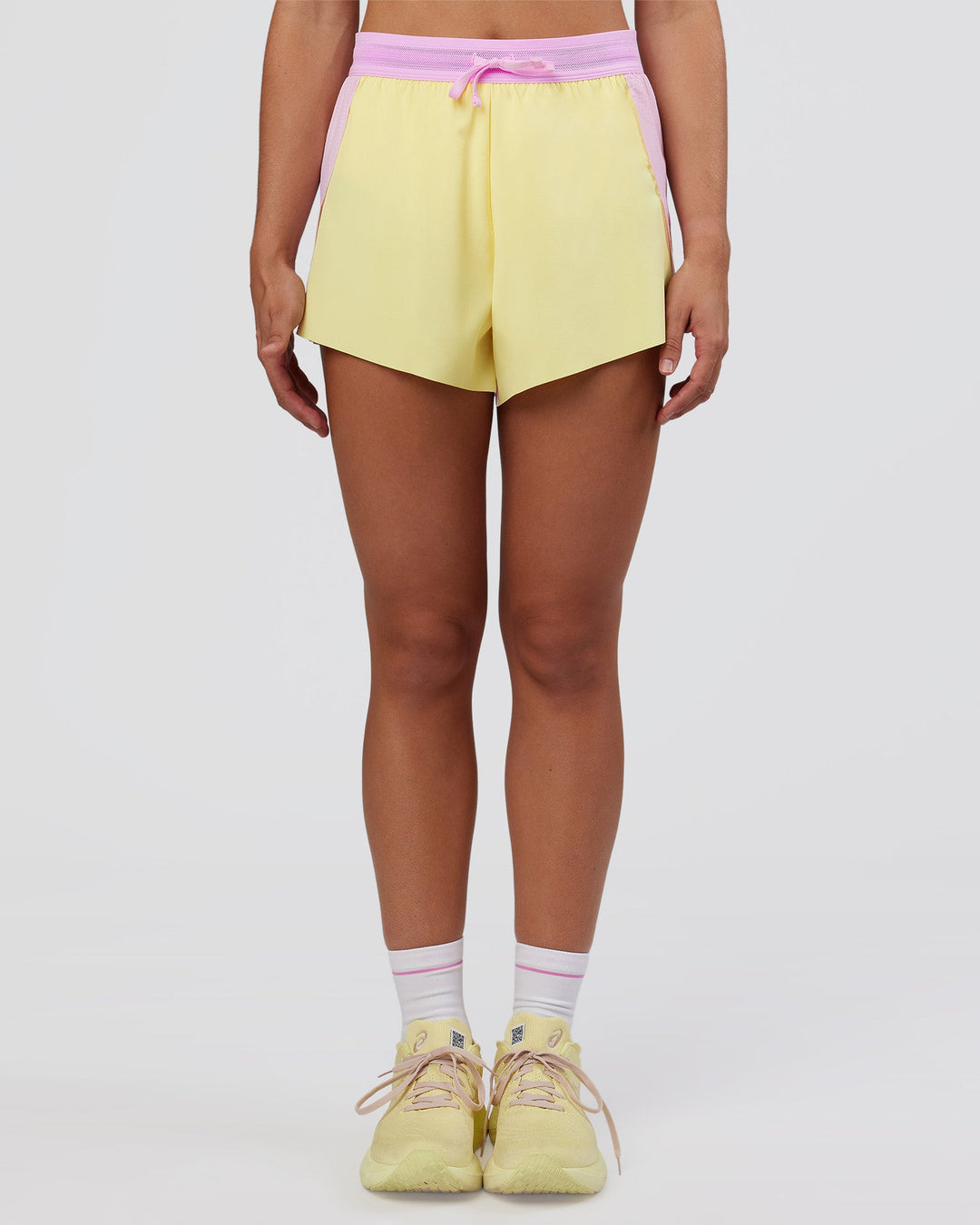 Woman wearing Accelerate 3&quot; High-Rise Running Short - Marshmallow-Lemon | Model:Grace | Size:S