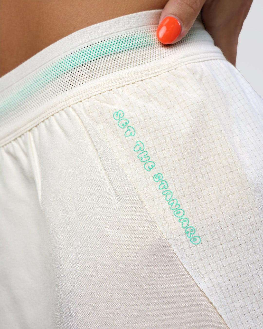 Woman wearing Accelerate 3" High-Rise Running Short - Off White-Floral Sticker | Model:Abbey | Size:S