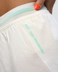 Woman wearing Accelerate 3" High-Rise Running Short - Off White-Floral Sticker | Model:Abbey | Size:S