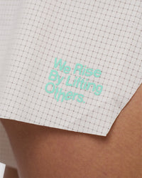 Woman wearing Accelerate 3" High-Rise Running Short - Off White-Floral Sticker | Model:Abbey | Size:S