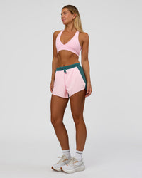 Woman wearing Accelerate 3" High-Rise Running Short - Transformative Teal-Marshmallow | Model:Amity | Size:S