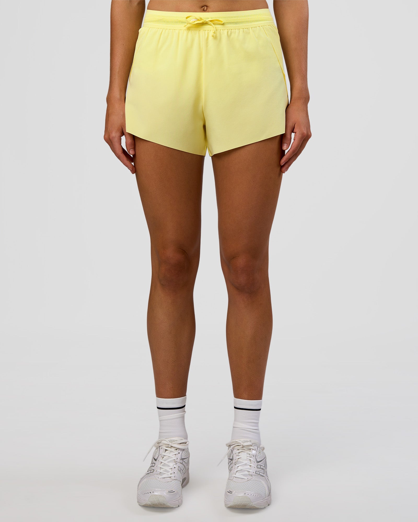 Woman wearing Accelerate 3" High-Rise Running Short - Yellow Fizz | Set:true | Angle:front | Model:Evie | Size:S