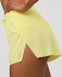Woman wearing Accelerate 3" High-Rise Running Short - Yellow Fizz | Model:Evie | Size:S