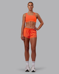 Woman wearing Accelerate 3" Run Short - Ultra Orange | Model:Charlize | Size:S