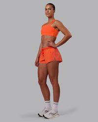 Woman wearing Accelerate 3" Run Short - Ultra Orange | Model:Charlize | Size:S
