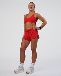 Woman wearing Accelerate 3" Mid-Rise Running Short - Flame | Model:Sav | Size:S