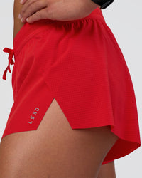 Woman wearing Accelerate 3" Mid-Rise Running Short - Flame | Model:Sav | Size:S