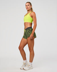 Woman wearing Accelerate 3" Mid-Rise Running Short - Friction Print Hyper Green | Model:Emelia | Size:S