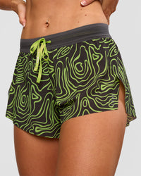 Woman wearing Accelerate 3" Mid-Rise Running Short - Friction Print Hyper Green | Set:true | Angle:closeup | Model:Emelia | Size:S