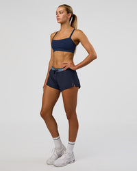 Woman wearing Accelerate 3" Mid-Rise Running Short - Future Navy-Baltic Sea | Model:Evie | Size:S