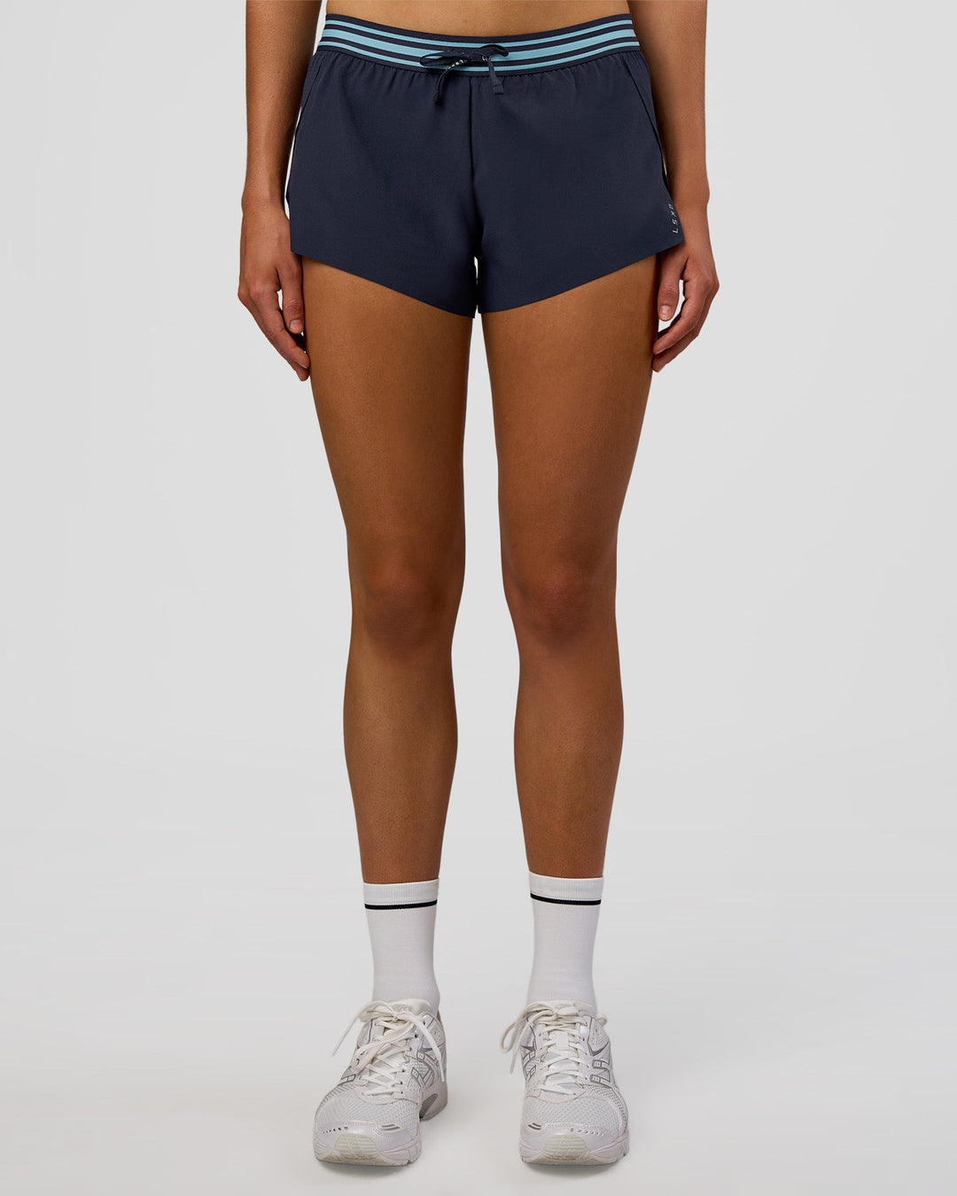 Woman wearing Accelerate 3" Mid-Rise Running Short - Future Navy-Baltic Sea | Model:Evie | Size:S