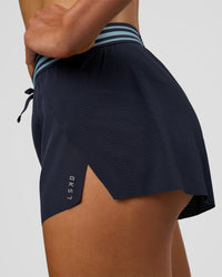 Woman wearing Accelerate 3" Mid-Rise Running Short - Future Navy-Baltic Sea | Model:Evie | Size:S